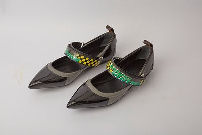 pair of women ' s black shoes with yellow and green trims
