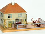 a small model of a house on a wooden platform
