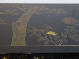 a black box with a painting of a tree on it