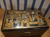 a black and gold box sitting on a wooden table