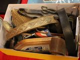 a box full of different types of shoes and a pair of scissors