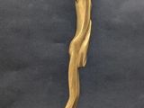 sculpture of a woman ' s head on a wooden base