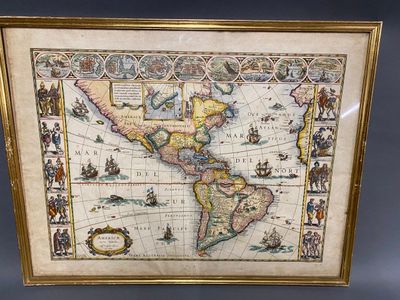 an old map of the americas is displayed in a gold frame