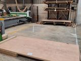 a large wooden floor in a building with a lot of wood on it