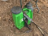 a green blower sitting on the ground next to a picnic table