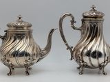 pair of antique silverplated teapots on stand