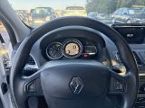 the steering wheel of a car with a clock on the dashboard