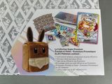 pokemon trading card game in a box with a stuffed animal
