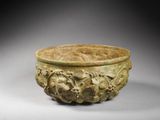 an old, carved bowl with a design on it