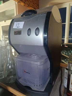 a coffee machine sitting on top of a counter in a kitchen