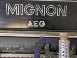 a close up of an old typewriter with the word mignon on it