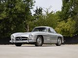 a silver mercedes 300sl is parked in a parking lot