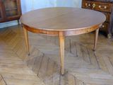 a wooden table that is on wheels in a room