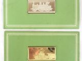 two green and gold business cards with a picture of a train on them