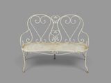 an image of a white wrought bench on a grey background