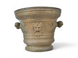 a large stone vase with a lion head on it