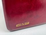 an image of a red purse sitting on top of a white table