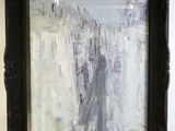 an oil painting of a cityscape in a black frame hanging on a wall