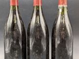 three bottles of wine sitting next to each other on top of a table