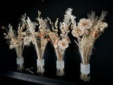 five vases with dried flowers in them on a shelf