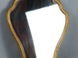 an image of a mirror with a gold frame on a gray background
