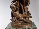 bronze statue of a boy and a girl on a marble base