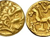 a gold coin with a picture of a horse on it