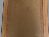an old picture of a picture in a cardboard box on a table