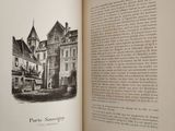 an open book with a black and white drawing of a castle