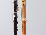 two different types of clarinets sitting on a stand