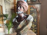 a bust of a man with a turban on top of a table
