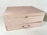 a pink box with two drawers on top of it