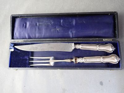 a silverware set in a blue box with a knife and fork