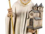 figurine of a saint holding a small church and a staff