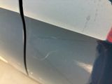 a close up of a car ' s door handle with a sticker on it