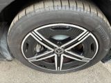 a close up of a car ' s tire on the street