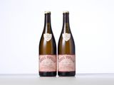 two bottles of wine sitting next to each other on a table