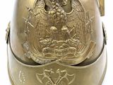 an old brass helmet with a large eagle on the front
