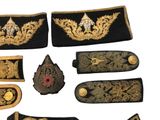 several different types of military uniforms are displayed on a white surface