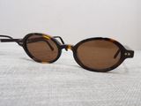 vintage tortoise sunglasses with brown lenses on a white surface
