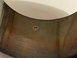 a close up of a piece of metal with a hole in it