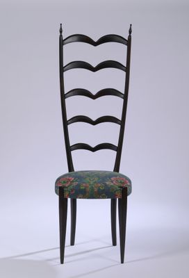 une chaise noire dont l'assise est recouverte d'un tissu à motifs floraux
