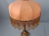 an image of a table lamp with a pink shade on it