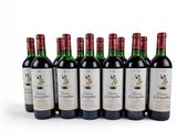 six bottles of red wine lined up in a row on a white surface