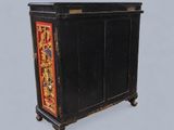 a black cabinet with a red and gold design on it