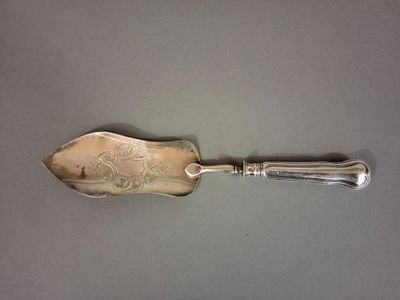 a silver spoon with a silver handle on a table