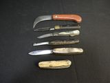 several different types of knives are lined up on a black surface