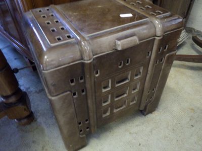 a brown suitcase sitting on the floor next to a chair
