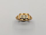 a gold ring with a diamond and two diamonds in the center