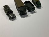 four toy trucks that are sitting on a table